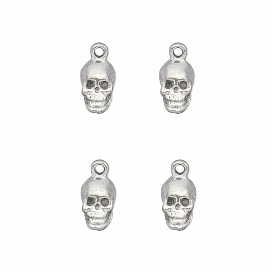 Four silver skull charms with top loops, arranged in a 2x2 grid on a plain white background.