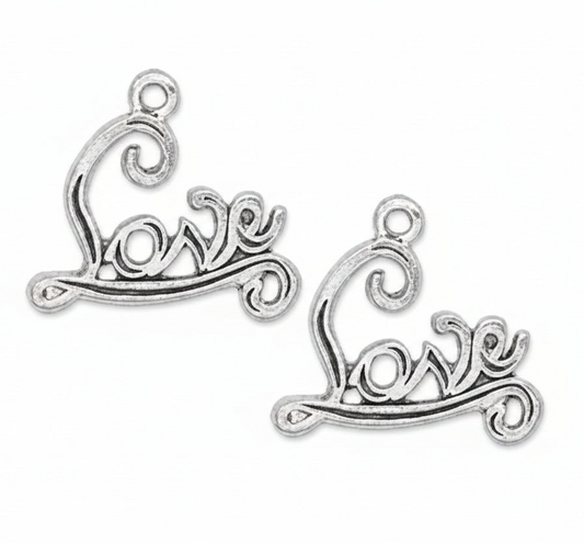 Two silver-toned metal charms shaped like stylized cursive script reading 'love' with decorative swirls at the top, shown on a plain white background.
