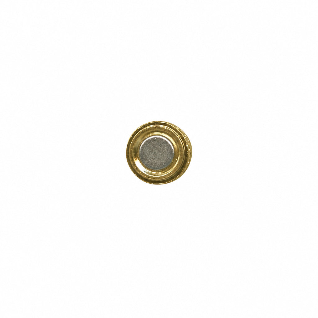 A small round gold-toned button or stud with a textured silver-gray center, isolated on a plain white background.