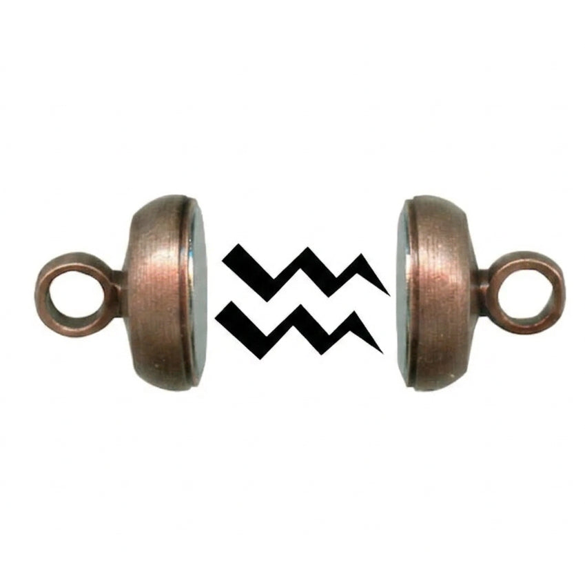 Two small copper-toned metal ring hardware pieces shown side by side on a white background, with a black zigzag graphic between them.