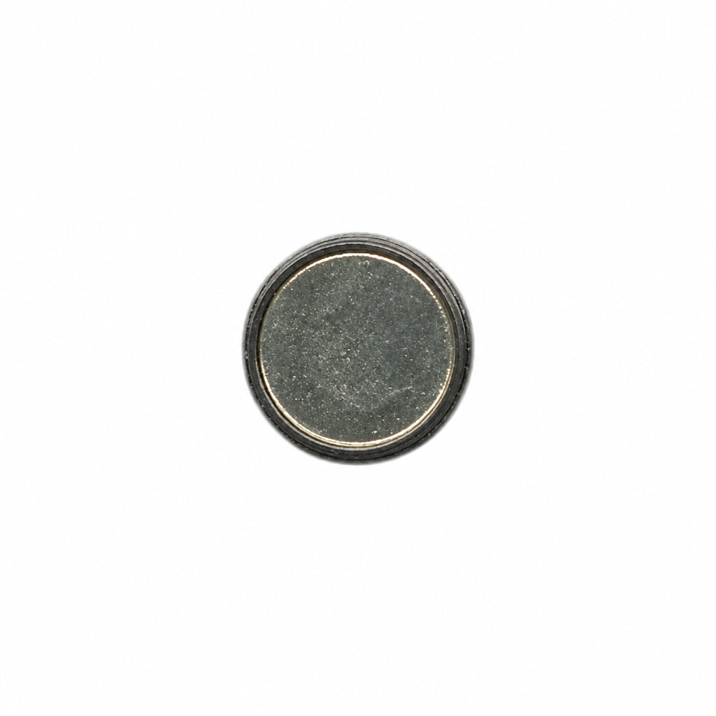 A single round, flat button with a textured dark gray center and a metallic silver outer rim, isolated on a white background.