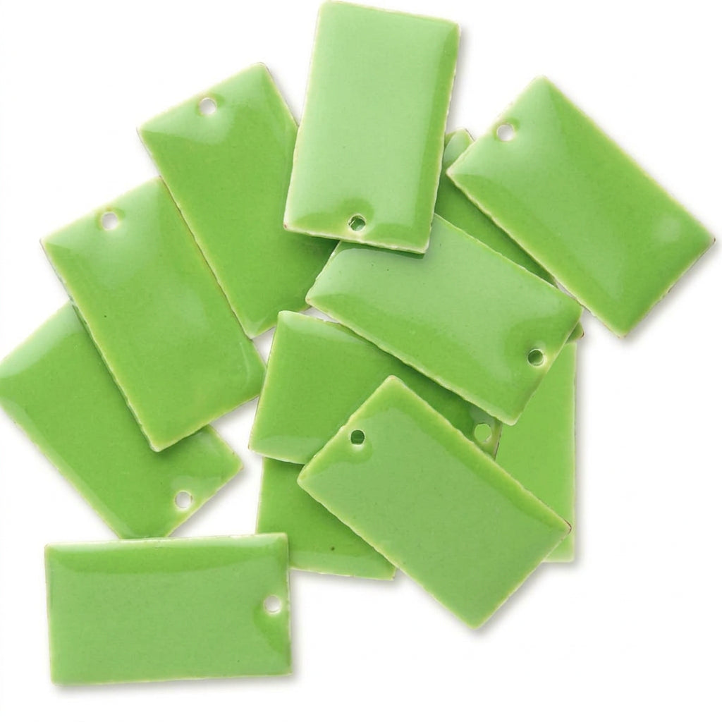 A pile of bright lime green rectangular ceramic tiles with pre-drilled holes, arranged on a plain white background.
