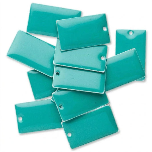 A pile of glossy rectangular turquoise beads with pre-drilled holes, shown on a plain white background.