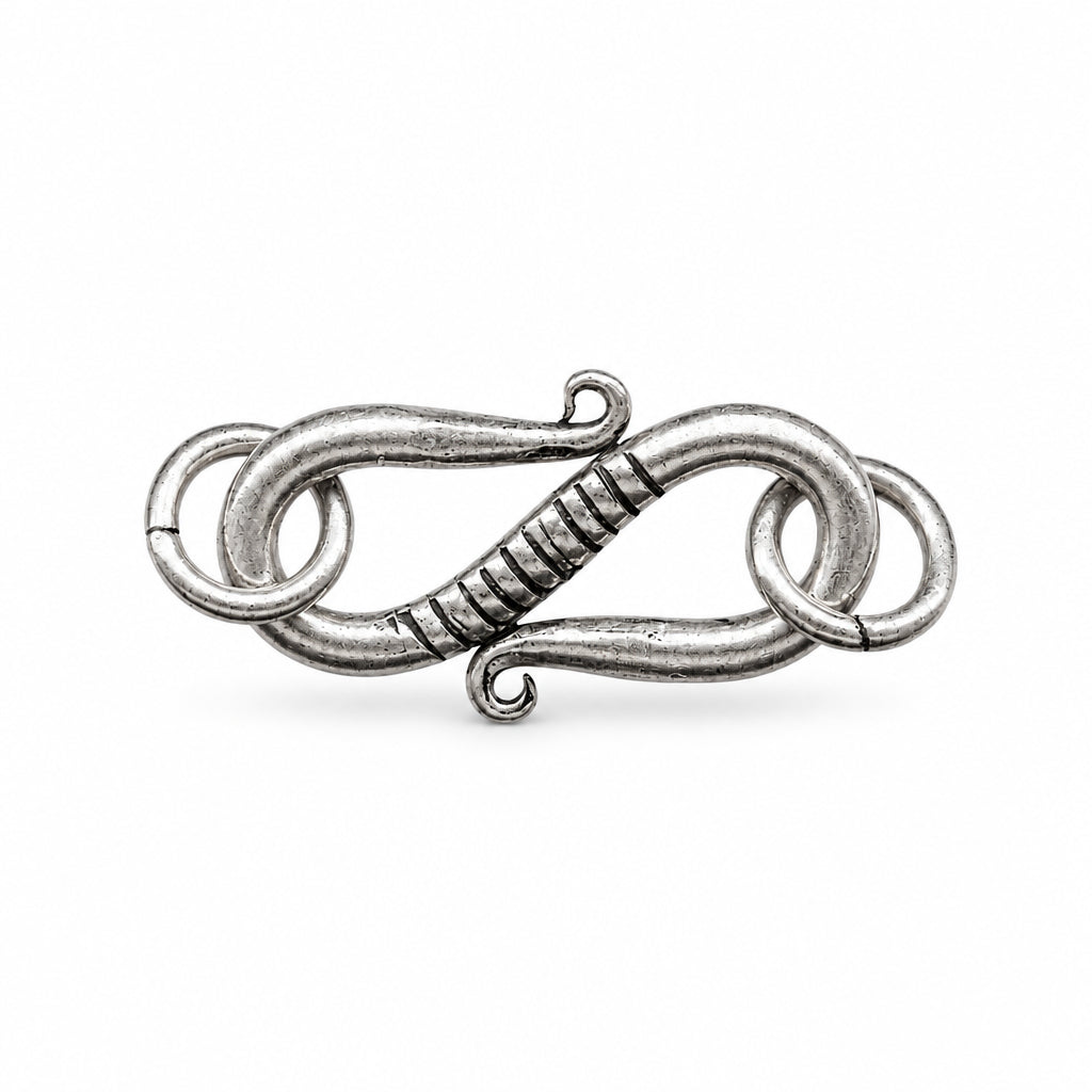 A silver-toned metal toggle clasp with a twisted center section and interlocking loop details, shown on a plain white background.