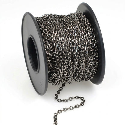 A spool of dark metallic chain links, shown on a clean white background with a short section of the chain draped in front.