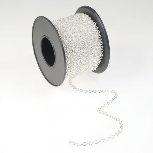 A spool of silver chain link cord, with the chain unwinding slightly, set against a plain white background.