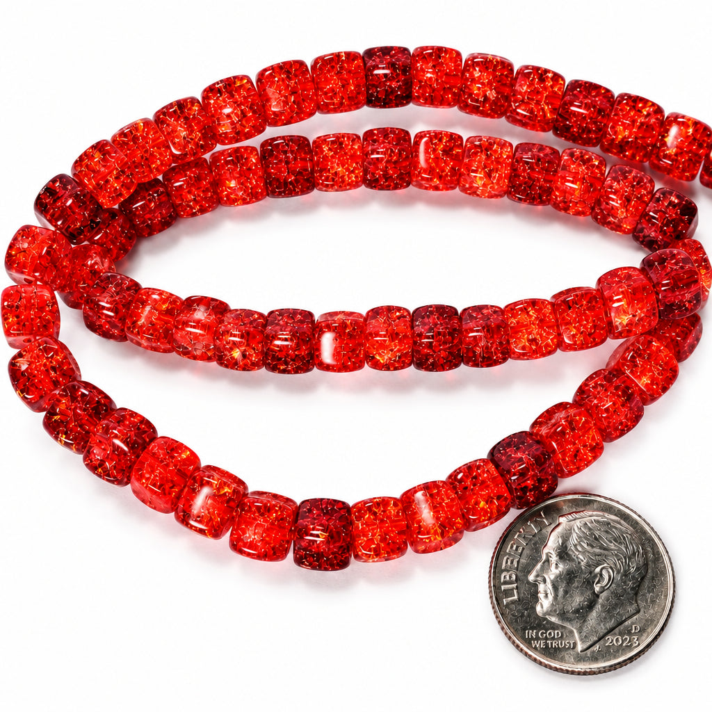 Red faceted glass beads, likely from a beaded necklace or bracelet, shown in two loops with a US quarter coin for scale on a white background.