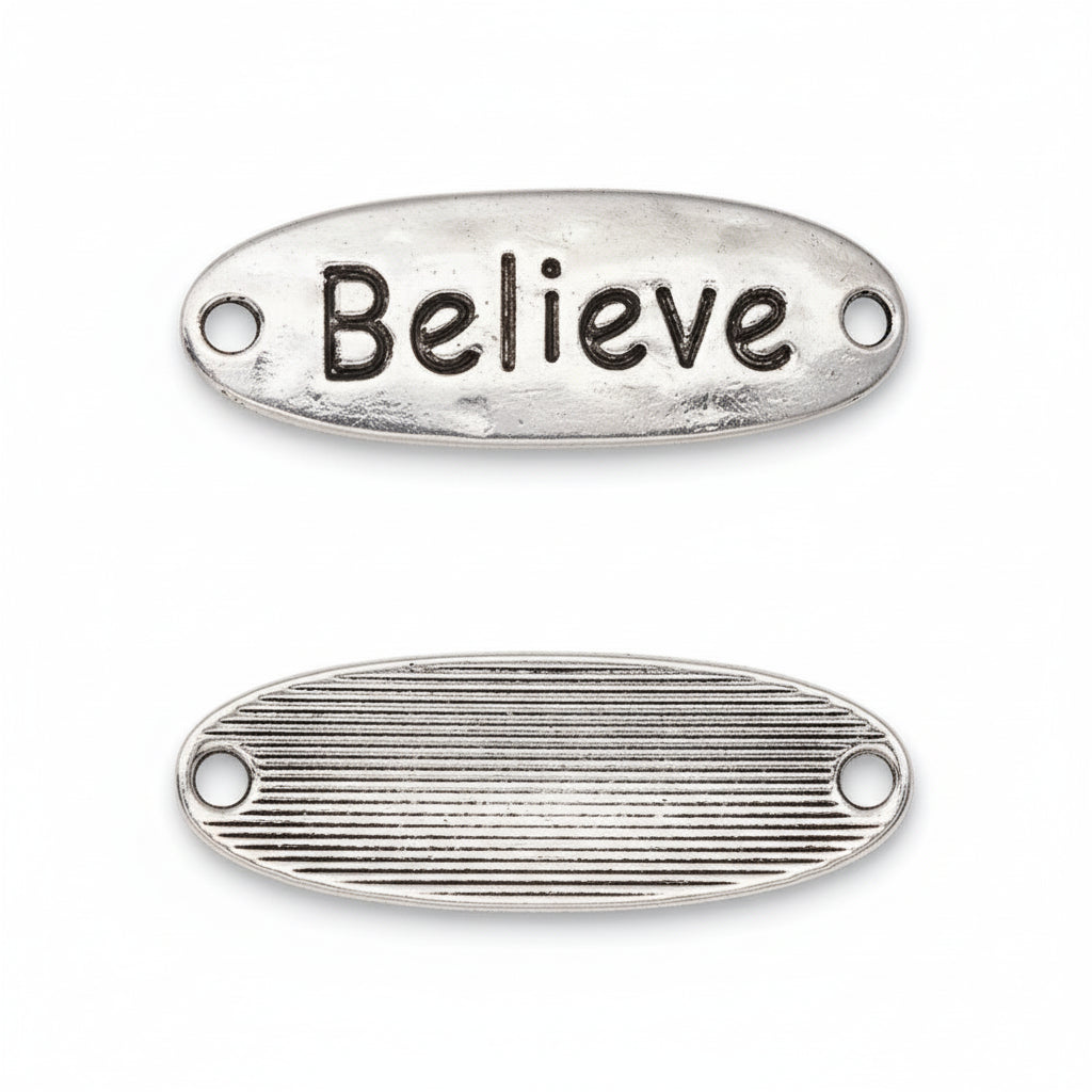 Two oval silver metal charms with holes, one showing the raised 'Believe' text on the top surface and the other showing the ribbed textured bottom, on a white background.
