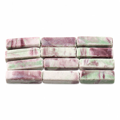 Rectangular polished stone beads with a marbled pattern of pinkish-purple and light green on a white base, arranged in rows on a white background.