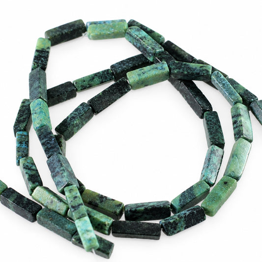 A coiled strand of rectangular faceted beads in a mottled green and black stone, likely jasper or turquoise, on a plain white background.