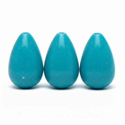 Three glossy turquoise teardrop-shaped beads with a small hole at the top, arranged in a row on a white background.