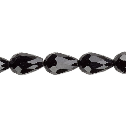 Faceted black teardrop beads on a plain white background.