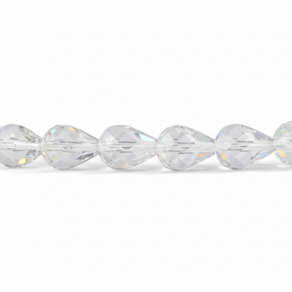 A close-up of a faceted clear bead strand, showing multiple transparent teardrop-shaped beads with prismatic cuts reflecting light on a white background.