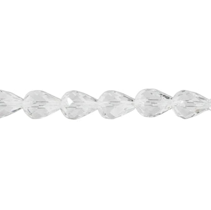 A close-up of a faceted clear crystal bead strand laid horizontally against a light gray background.