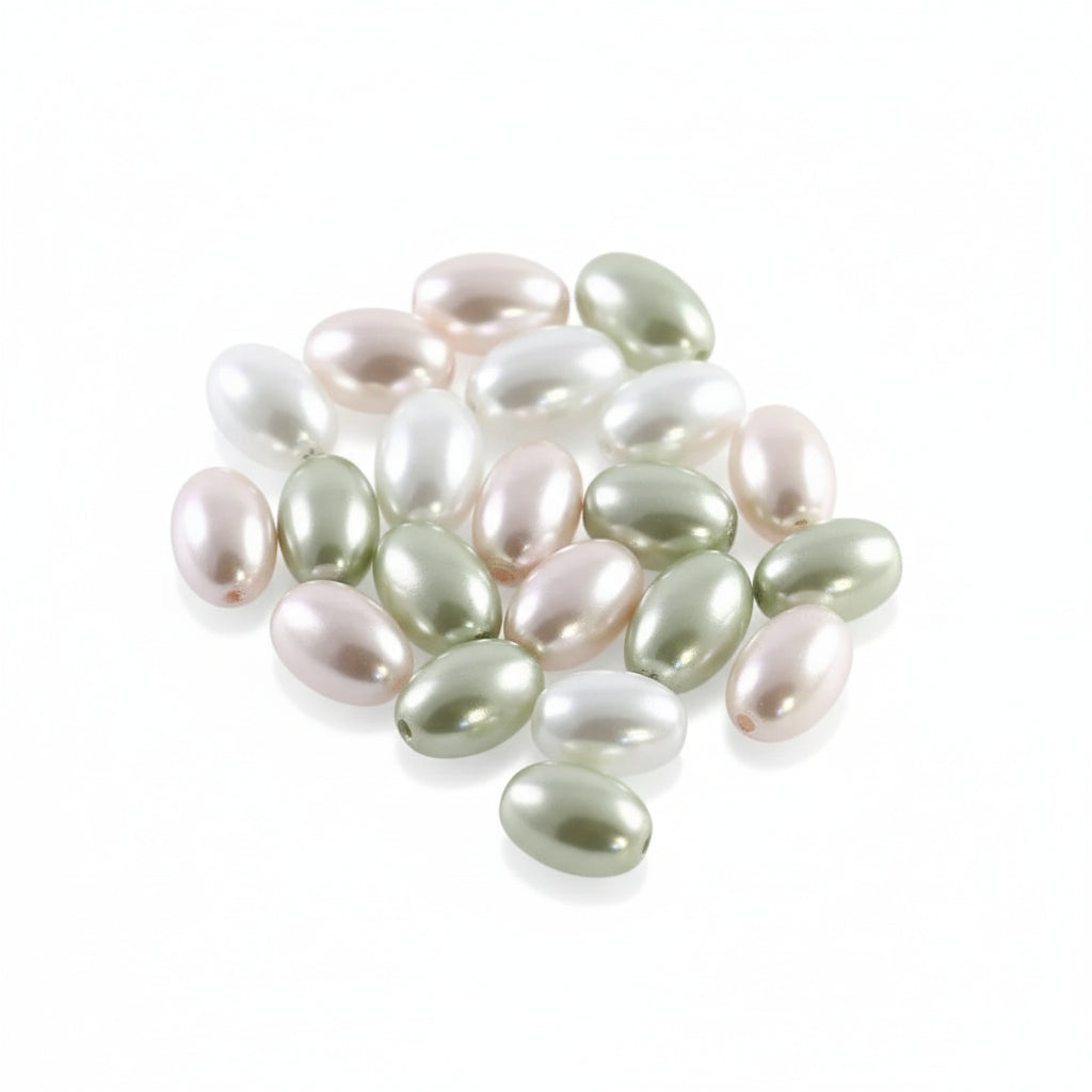 A pile of small, glossy, oval-shaped freshwater pearl beads in assorted colors including pale green, white, and soft pink, arranged on a plain white background.