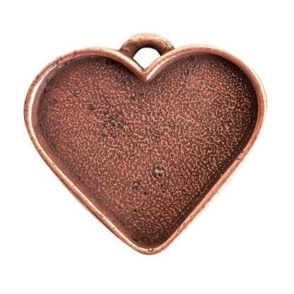 A heart-shaped metal jewelry charm with a textured, hammered finish in a warm copper or bronze tone, featuring a small loop at the top for attachment, shown on a plain white background.