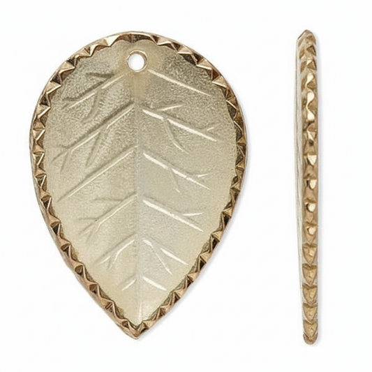 A gold-toned metal leaf-shaped charm with a textured embossed leaf pattern and a beaded border, shown from the front and side on a white background.