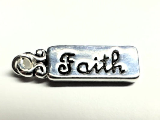 Silver charm with 'Faith' engraved on a white background