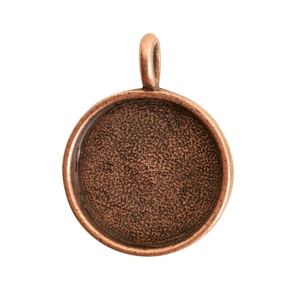 A round copper-colored bezel setting pendant with a textured, glittery bronze interior and a small top loop, shown on a plain white background.