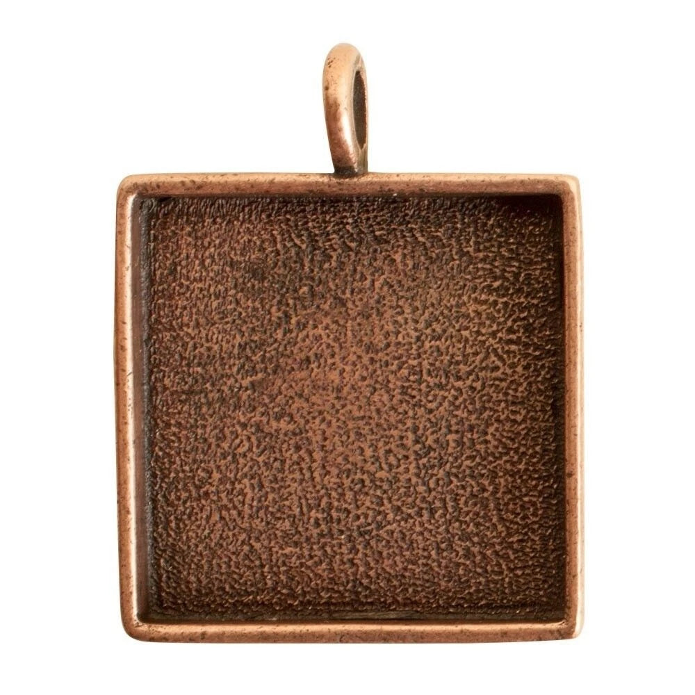 A square copper-toned bezel pendant with a textured interior and a top loop, shown on a plain white background.