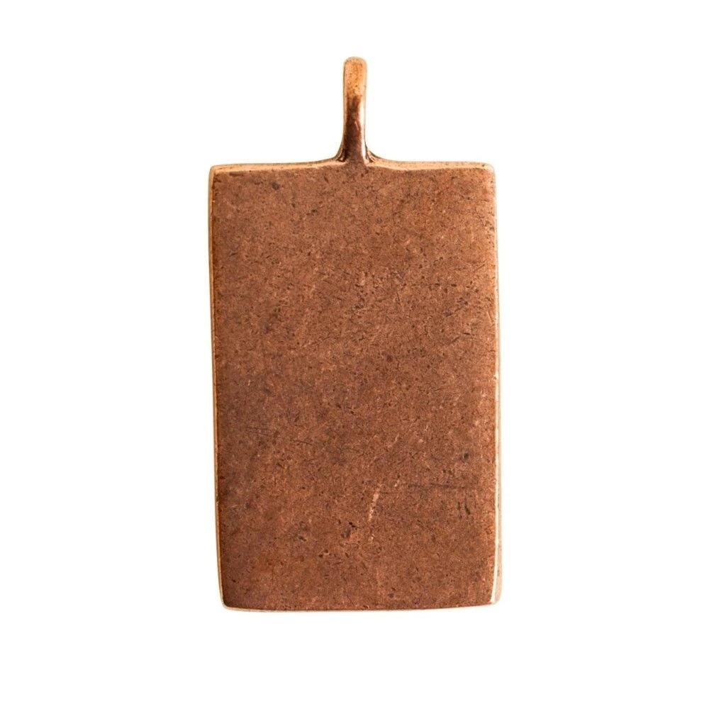 A rectangular copper pendant with a textured finish and a small loop at the top, shown against a plain white background.