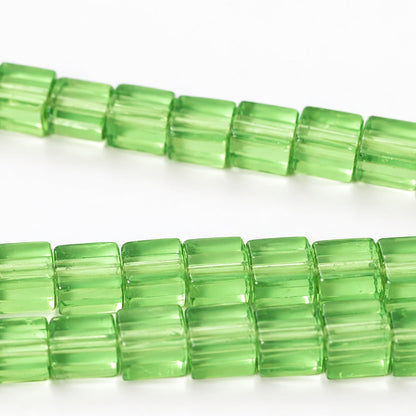 Green translucent rectangular beads strung in diagonal rows on a white background.