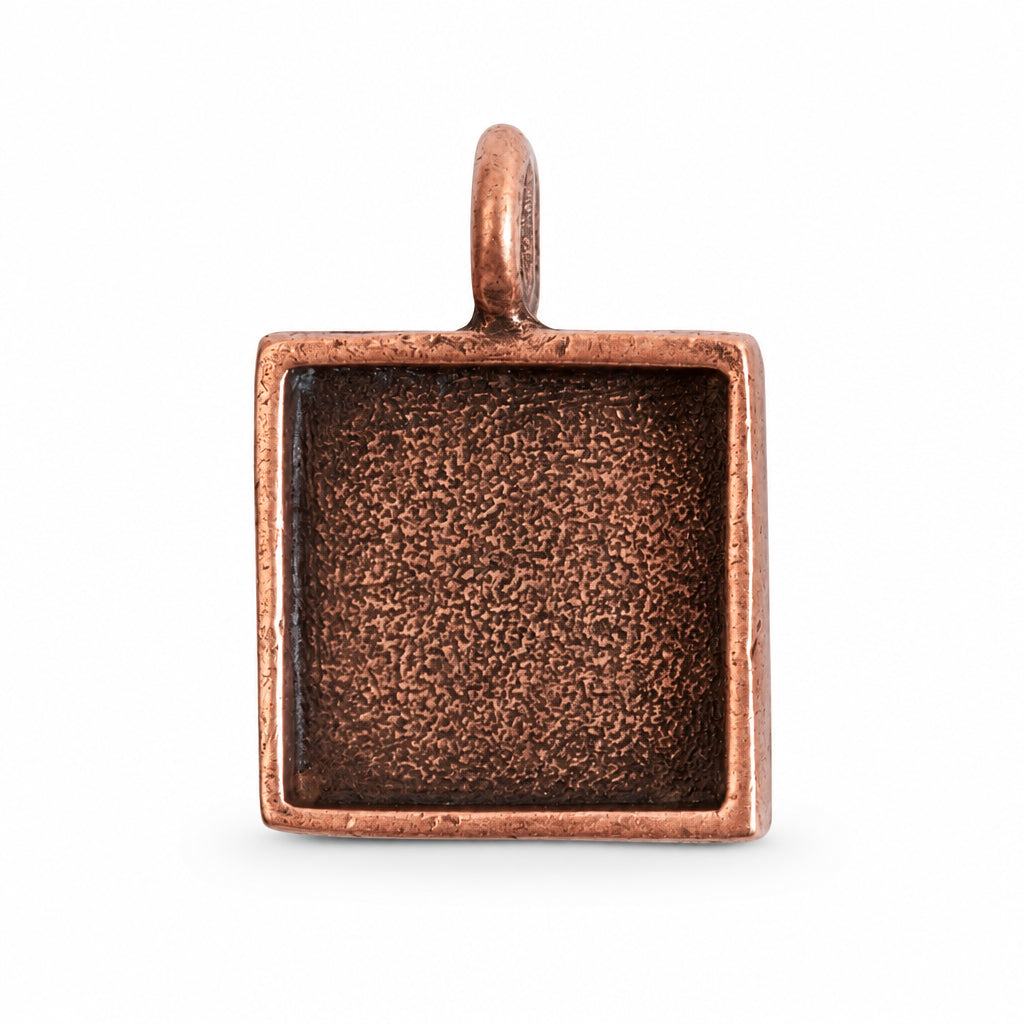 A square copper pendant with a textured, oxidized dark interior and a small top loop, shown on a plain white background.
