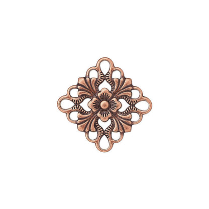 An ornate, vintage-style metal decorative connector piece with a copper/bronze finish and a central loop, isolated on a white background.