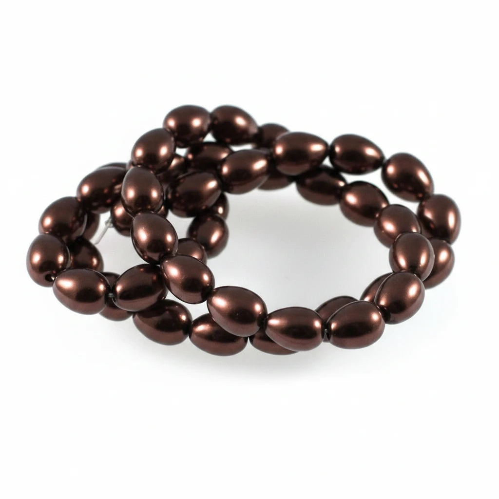 A strand of glossy, dark metallic brown teardrop-shaped beads coiled on a plain white background.