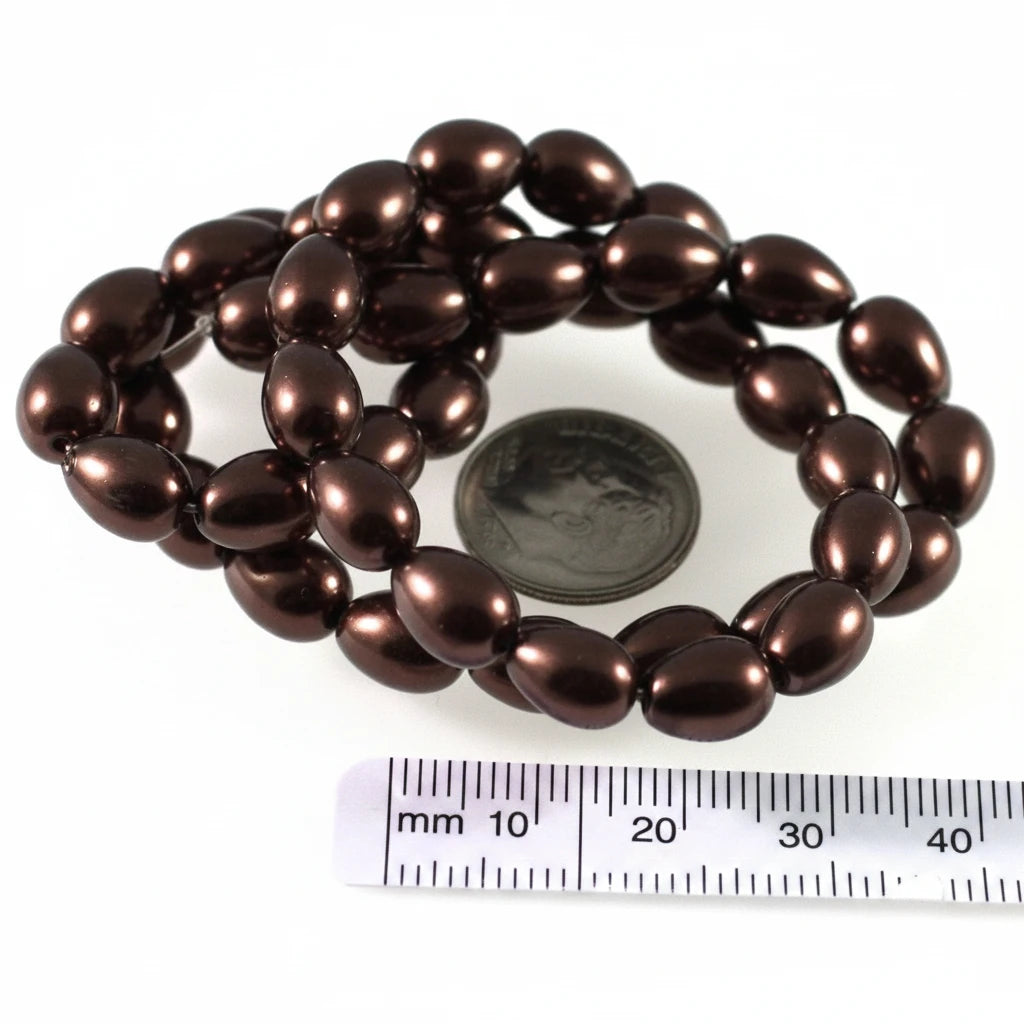 A strand of glossy, dark brown oval beads displayed on a white background, with a US quarter coin and a millimeter ruler included for scale.