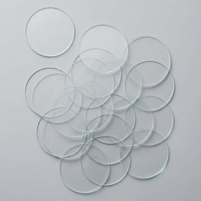 Multiple clear GLASS SLIDE discs on a white background