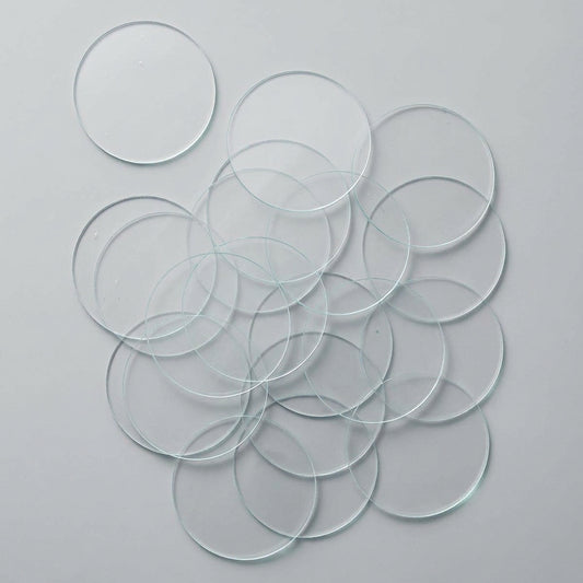Multiple clear GLASS SLIDE discs on a white background