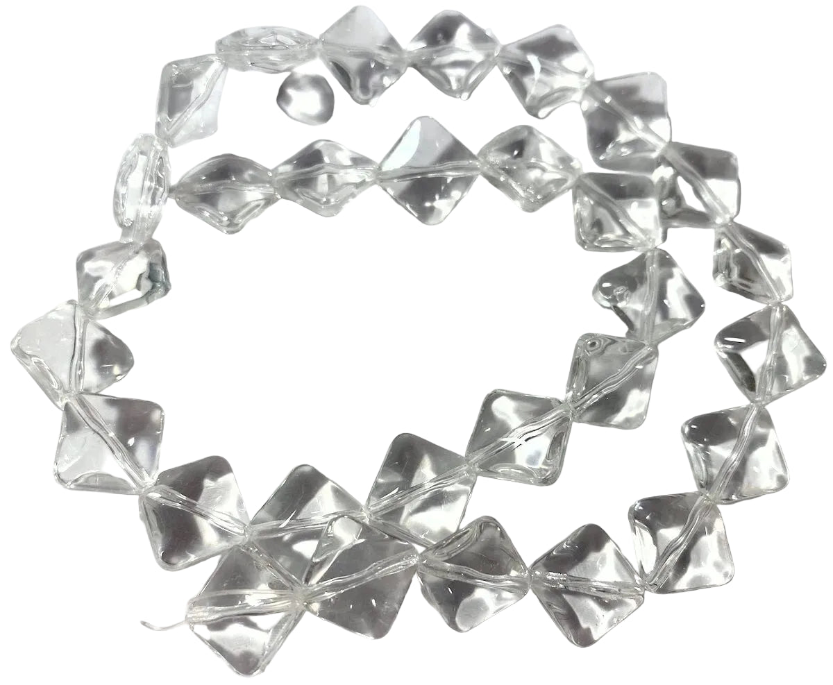 A strand of clear, faceted glass beads arranged in a circle on a white surface, with a US quarter coin placed in the center for scale.