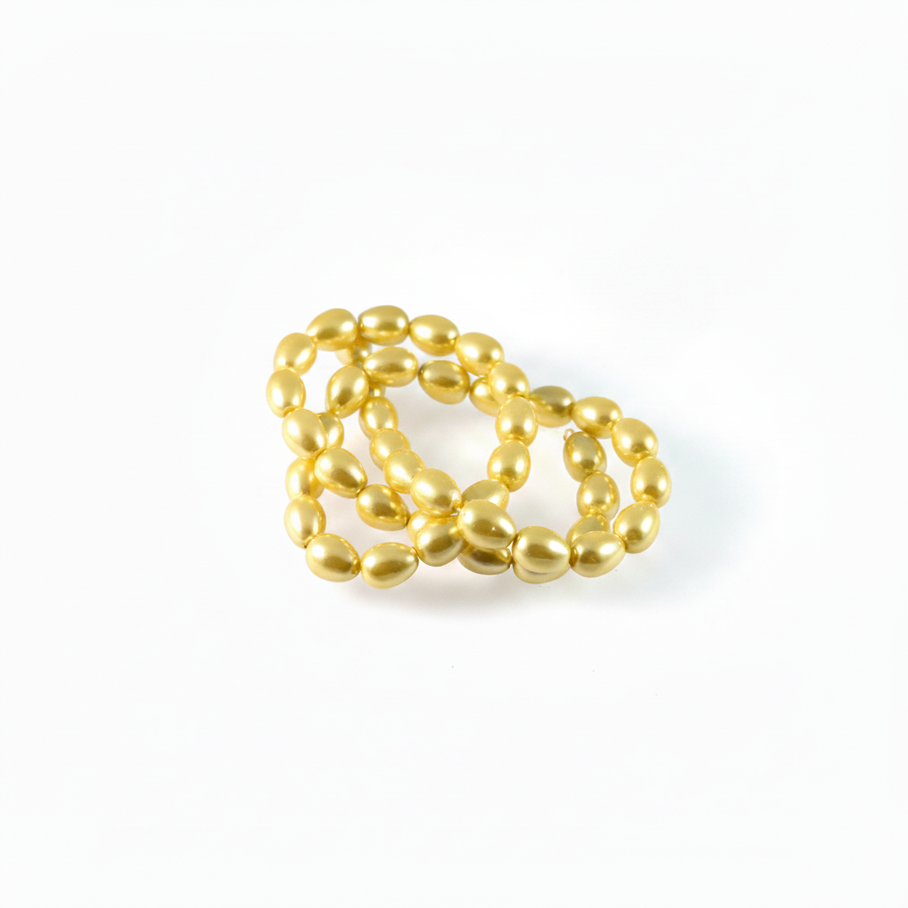 A cluster of shiny gold magnetic beads arranged in a small loop on a clean white background.