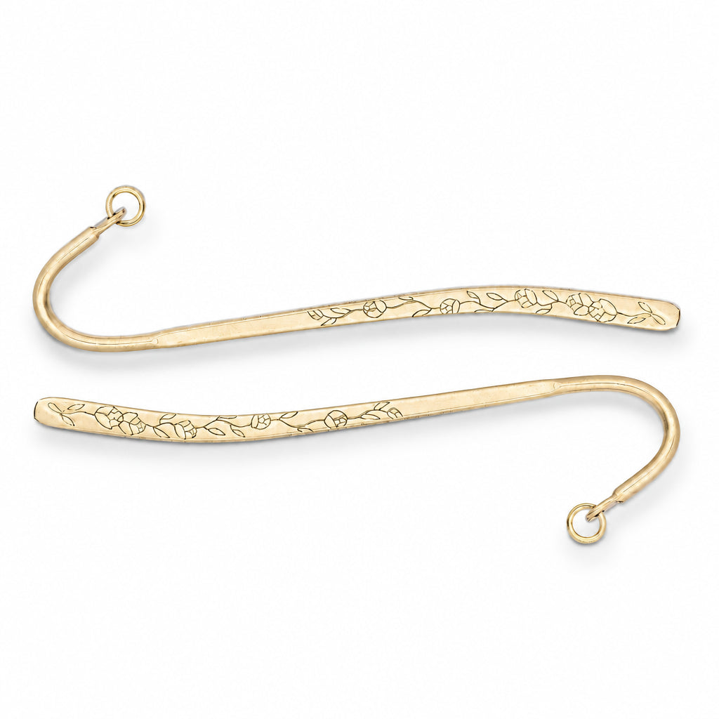 Two gold metal bookmark hooks with engraved floral patterns, shown on a plain white background.