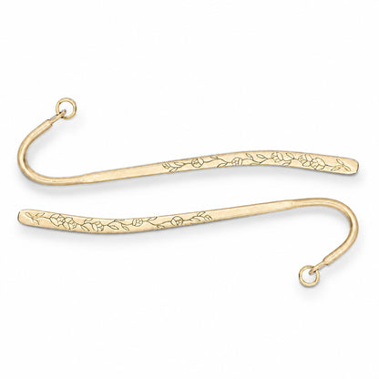 Two gold metal bookmark hooks with engraved floral patterns, shown on a plain white background.