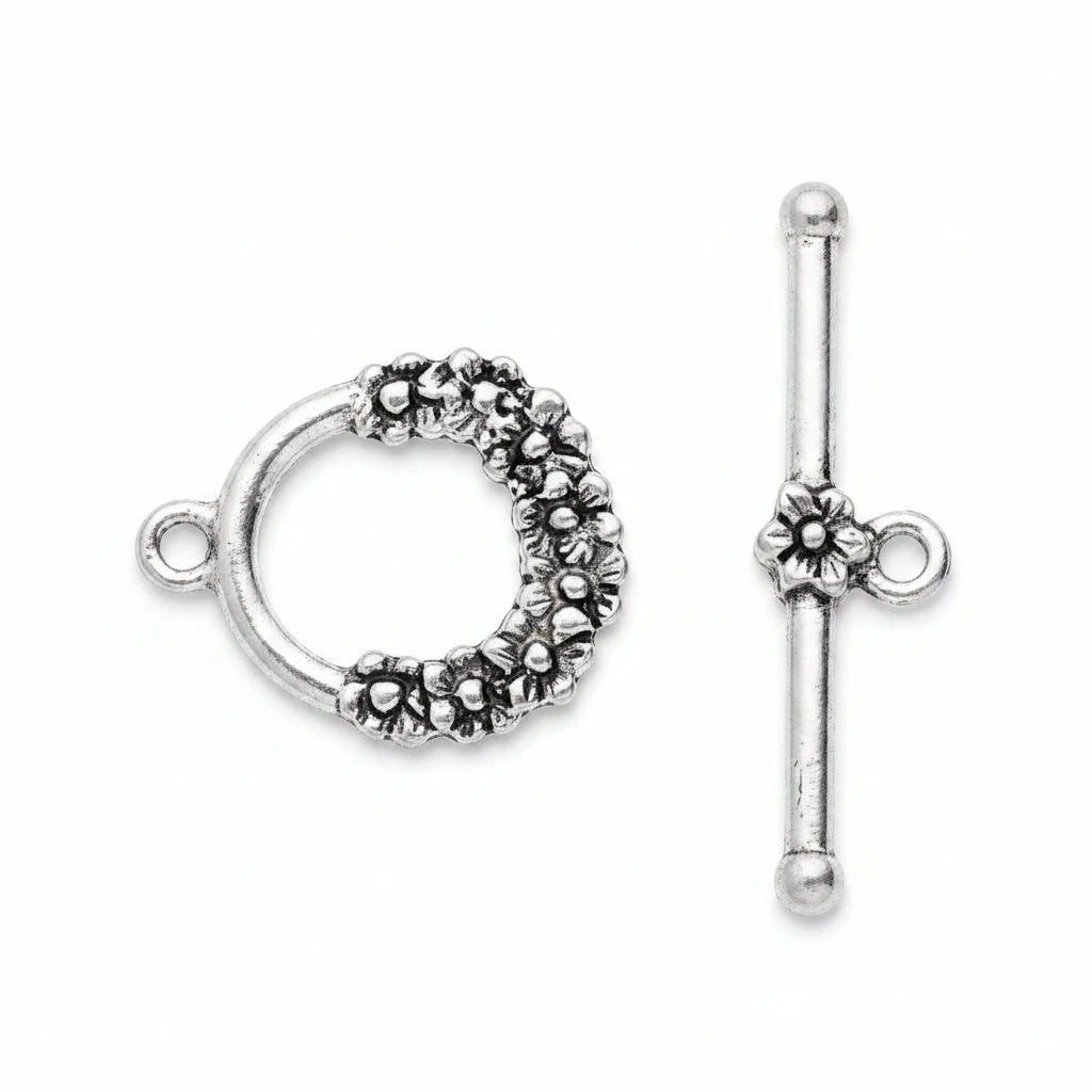 Silver-tone toggle clasp for jewelry, featuring a textured circular ring with a small loop on one side and a matching flower detail on the toggle bar, shown on a plain white background.
