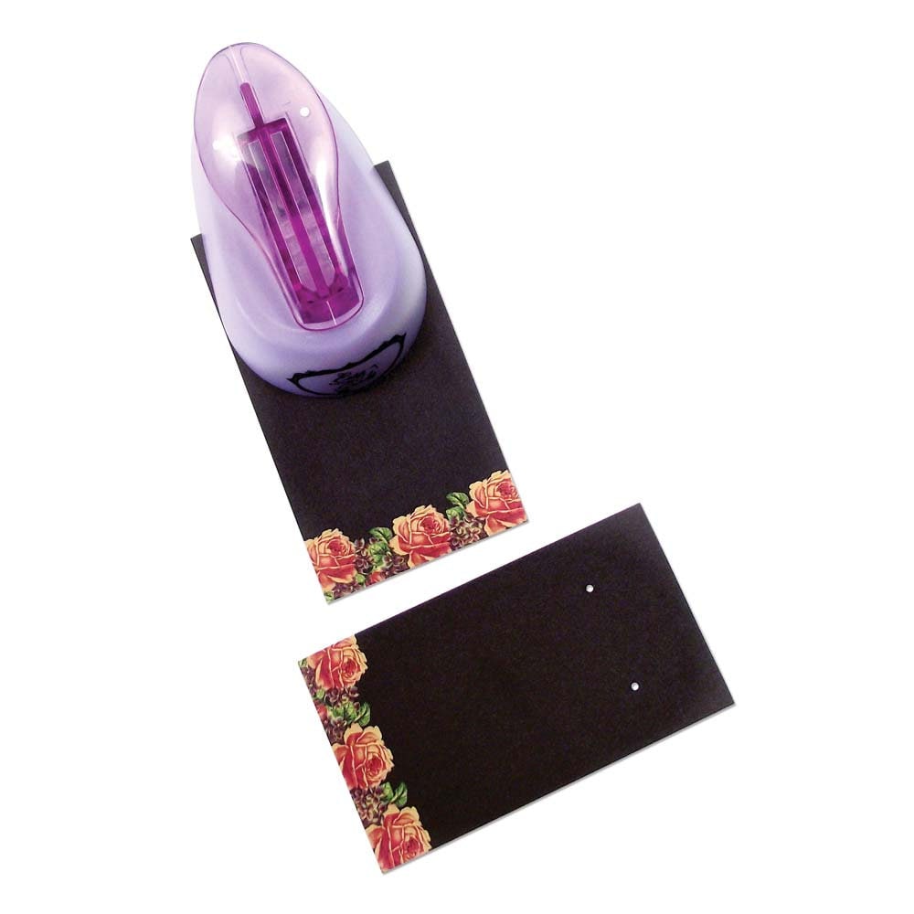 Purple hole puncher on a black mat with floral design on a white background