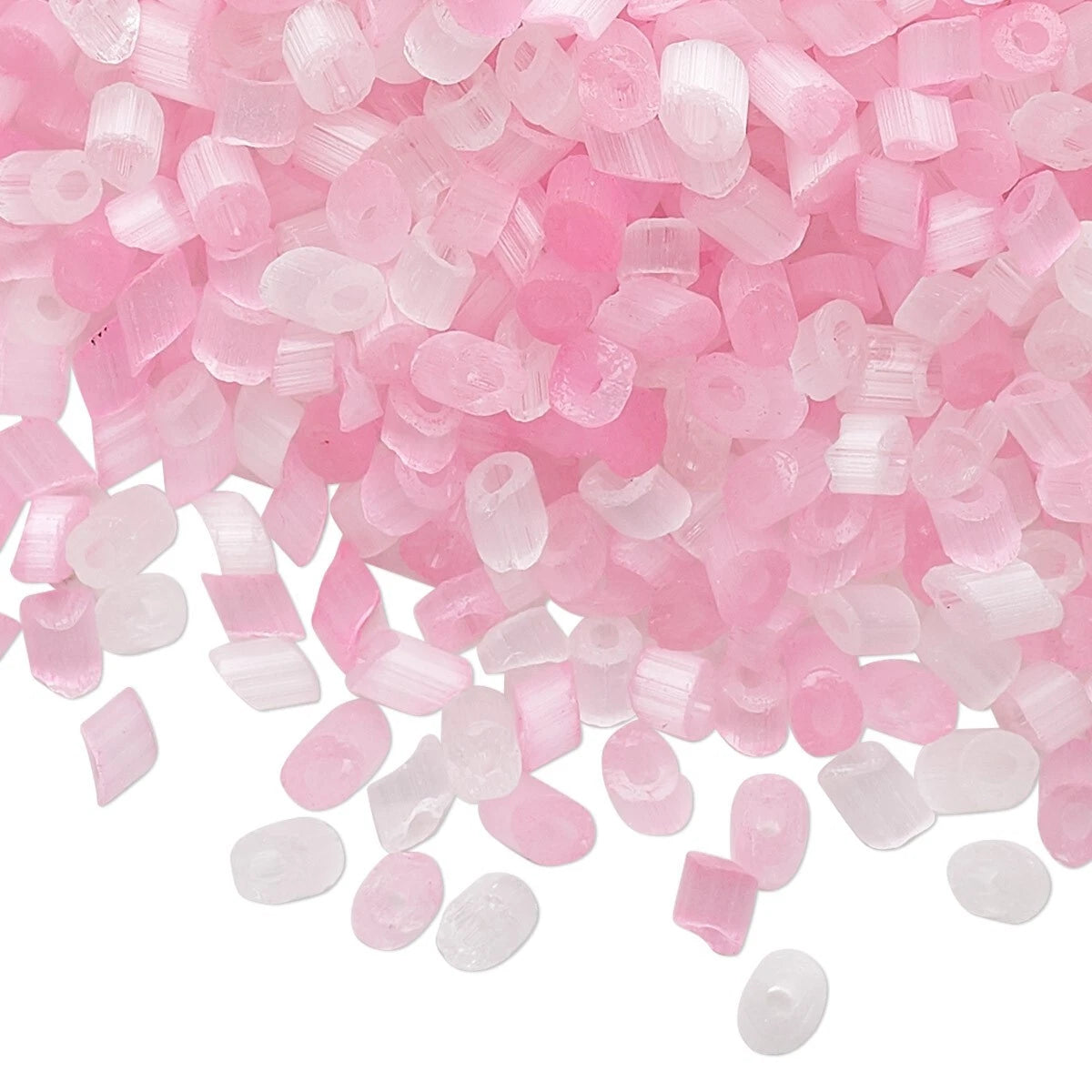 Pink and translucent white acrylic nail art beads scattered on a white background.