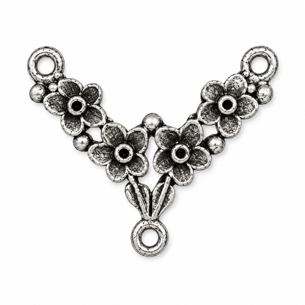 An antique silver Y-shaped jewelry connector charm featuring three floral motifs and three hanging loops, shown on a plain white background.