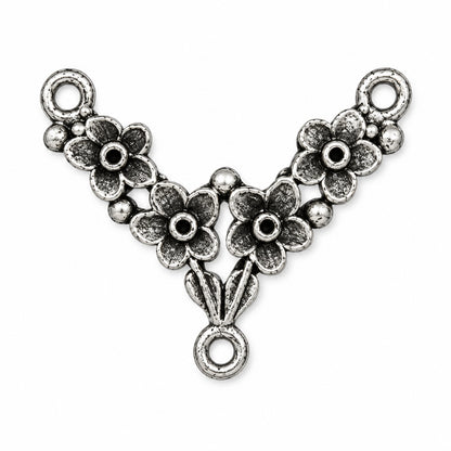 An antique silver Y-shaped jewelry connector charm featuring three floral motifs and three hanging loops, shown on a plain white background.