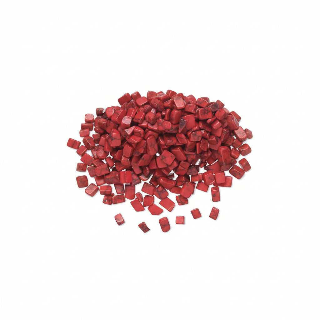 A pile of small, irregularly shaped red gemstone chips or beads scattered on a plain white background.