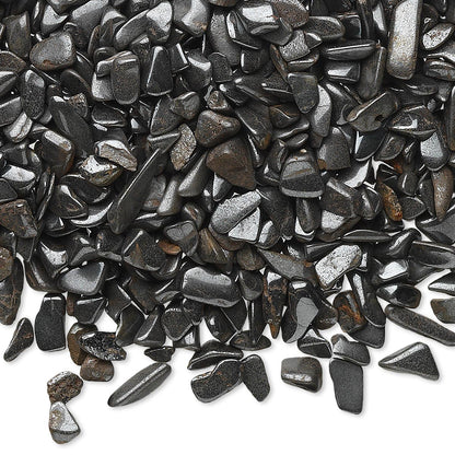 A pile of polished black river stones or pebbles with a glossy, metallic sheen, scattered across a white background.