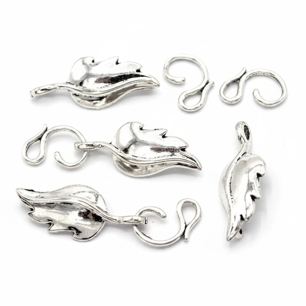 Six silver-toned leaf-shaped jewelry findings with loop backs, shown on a plain white background.