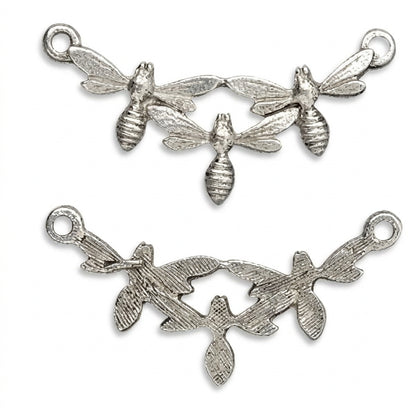 Two silver-toned metal jewelry findings on a plain white background: a top piece with three small bee motifs connected across a curved branch shape, and a bottom piece IS THE BACK SIDE