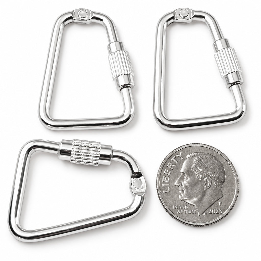 Four silver metal carabiner-style rings shown on a plain light background, with a silver coin placed for scale.
