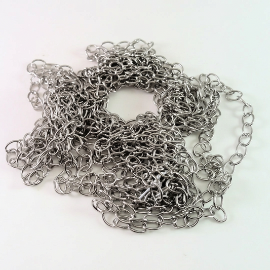 A coiled bundle of silver-toned metal chain links, photographed on a plain white background.