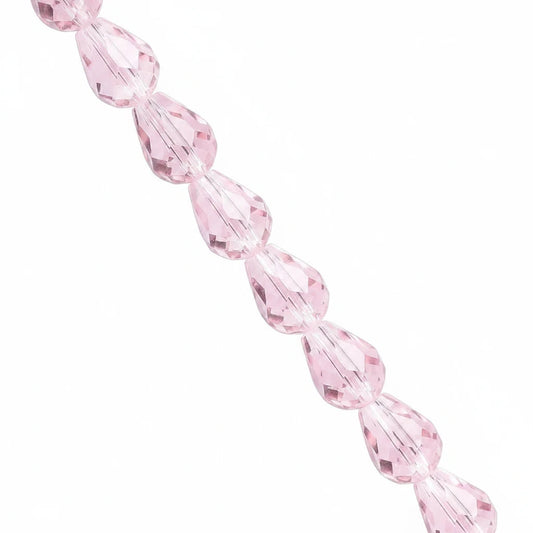 A strand of faceted light pink teardrop-shaped beads on a solid white background.