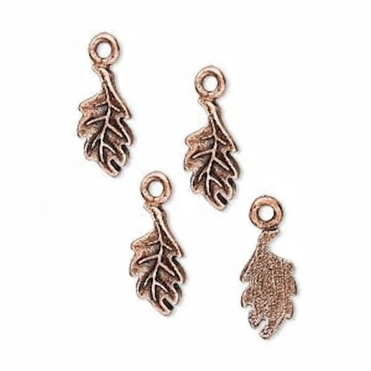 Four antique bronze leaf-shaped jewelry charms with loop tops, arranged on a plain white background.