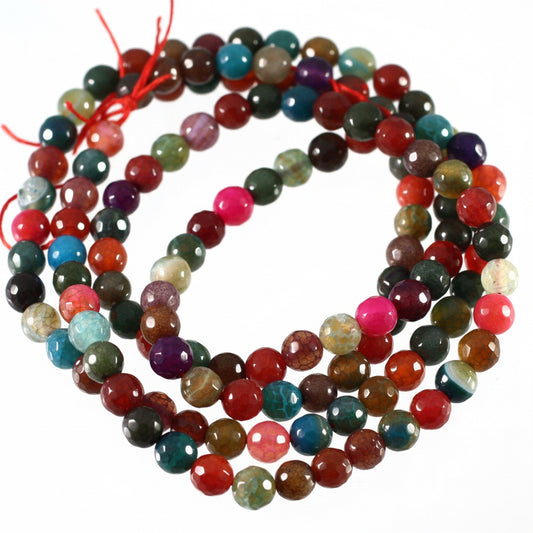 Multicolored gemstone beads on a white background